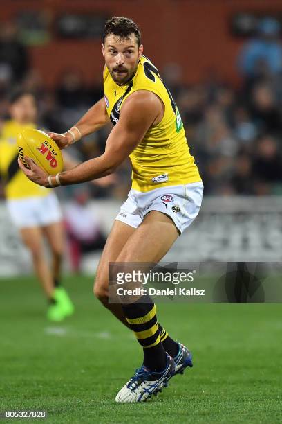 Toby Nankervis of the Tigers handballs during the round 15 AFL match between the Port Adelaide Power and the Richmond Tigers at Adelaide Oval on July...