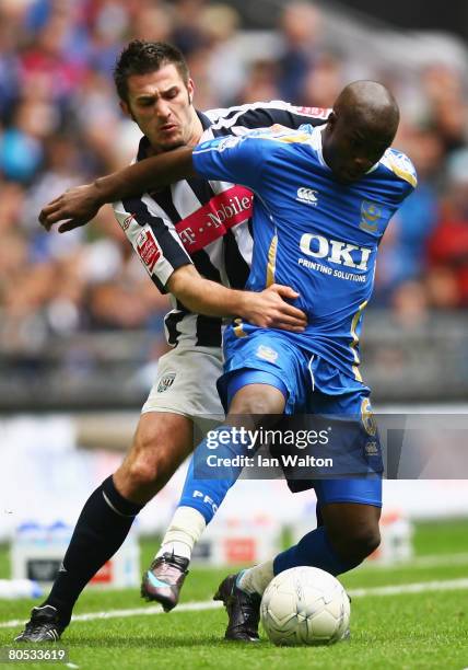 Carl Hoefkens of West Bromwich holds off Lassana Diarra of Portsmouth during the FA Cup sponsored by E.ON Semi-Final match between West Bromwich...