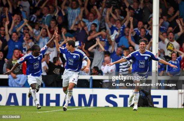 Peterborough's George Boyd celebrates his goal with team mates, Aaron McClean and Russell Martin during the Coca-Cola Championship match at London...