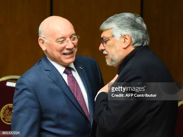 Paraguay's former President and new president of the Congress Fernando Lugo speaks with Paraguay's Foreign Minister Eladio Loizaga before the start...