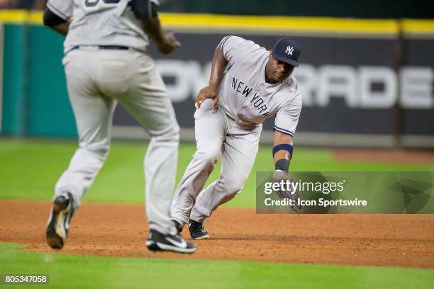 New York Yankees first baseman Chris Carter fields the baseball for the out on Houston Astros left fielder Marwin Gonzalez in the sixth inning during...