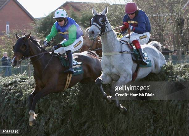 Eventual winner Comply Or Die ridden by Timmy Murphy comes over with Becher's Brook beside D'Argent ridden by Robert Thornton during the John Smith's...