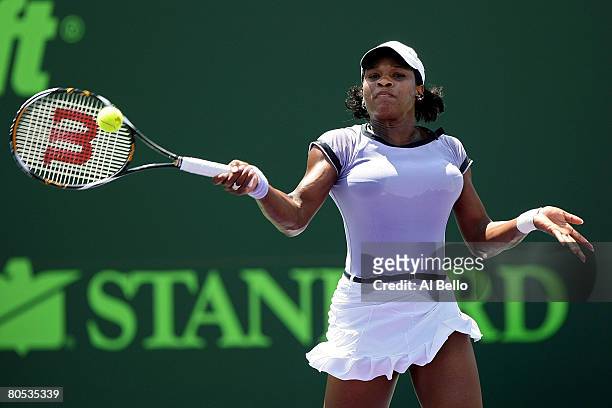 Serena Williams returns a shot against Jelena Jankovic of Serbia during the women's singles final on day thirteen of the Sony Ericsson Open at the...