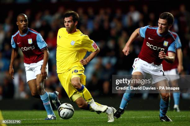 Cardiff City's Joe Ledley gets away from the challenge of Aston Villa's Craig Gardner during the Carling Cup Third Round match at Villa Park,...