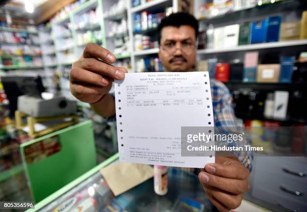 Shopkeeper showing new update GST bill outside the store at Connaught place on July 1, 2017 in New Delhi, India.