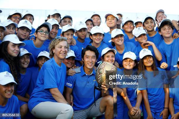 Yuichi Sugita of Japan receives his trophy after defeating Adrian Mannarino of France during their men's final match of ATP World Tour 250 Antalya...