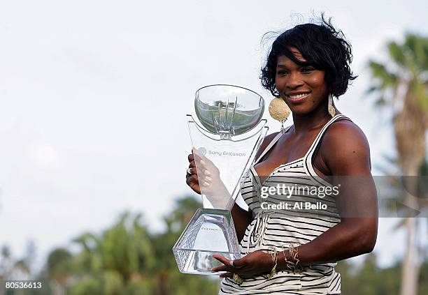 Serena Williams celebrates with the trophy after defeating Jelena Jankovic of Serbia to win the women's singles final on day thirteen of the Sony...