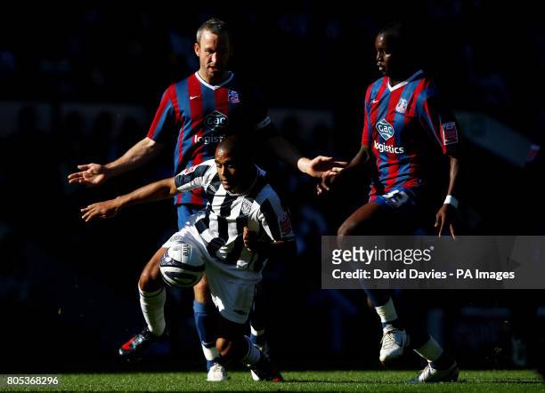 West Bromwich Albion's Albion's Luke Moore is challenged by Crystal Palace's Shaun Derry and Alassane N'Diaye action during the Coca-Cola...