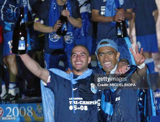 Porto's Jose Bosingwa and Argentinian Lisandro Lopez celebrate their victory on Estrela Amadora, 6-0, at the end of their Portuguese Super league...