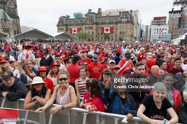 Crowds cheer during during Canada Day celebrations on Parliament Hill during a 3 day official visit by The Prince Of Wales & Duchess Of Cornwall to...