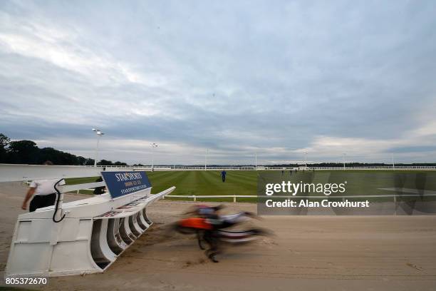 General view as runners leave the traps at Towcester greyhound track on July 1, 2017 in Towcester, England.