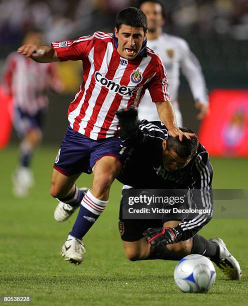 Alecko Eskandarian of CD Chivas USA makes his move around goalkeeper Nick Rimando of Real Salt Lake for a breakaway en route to a goal in the second...