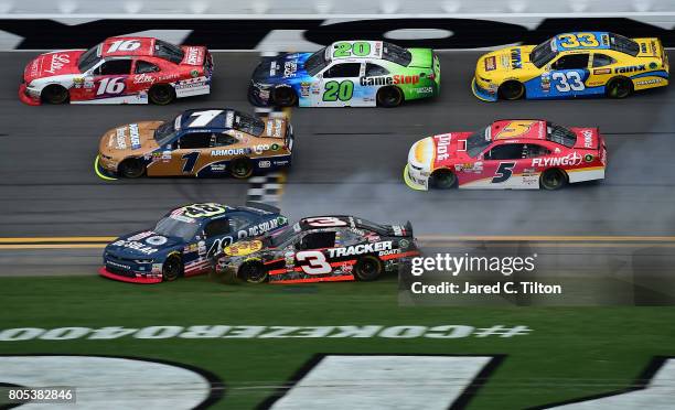 Brennan Poole, driver of the DC Solar Chevrolet, and Ty Dillon, driver of the Bass Pro Shops/TRCKR BTS Chevrolet, are involved in an on-track...