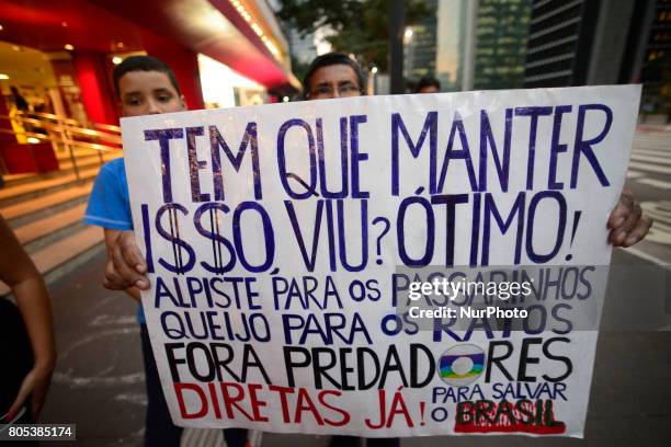 Members of the Roofless Movement call for Brazilian President Michel Temer to step down and protest against his proposed economic reforms, at...