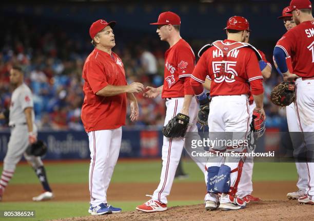 Lucas Harrell of the Toronto Blue Jays exits the game as he is relieved by manager John Gibbons in the ninth inning during MLB game action against...