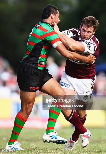 Josh Perry of the Sea Eagles is tackled by the Rabbitohs defence during the round four NRL match between the Manly Warringah Sea Eagles and the South...