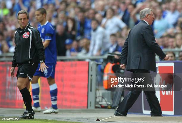 Manchester United manager Alex Ferguson walks away from fourth official Alan Wiley after venting his frustration