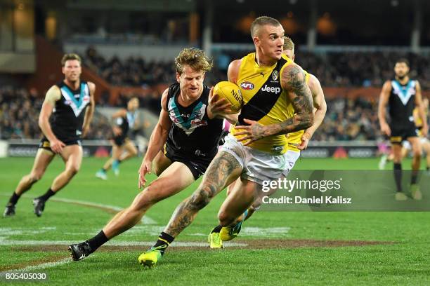 Dustin Martin of the Tigers runs with the ball during the round 15 AFL match between the Port Adelaide Power and the Richmond Tigers at Adelaide Oval...