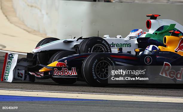 Jenson Button of Great Britain and Honda Racing collides with David Coulthard of Great Britain and Red Bull Racing during the Bahrain Formula One...