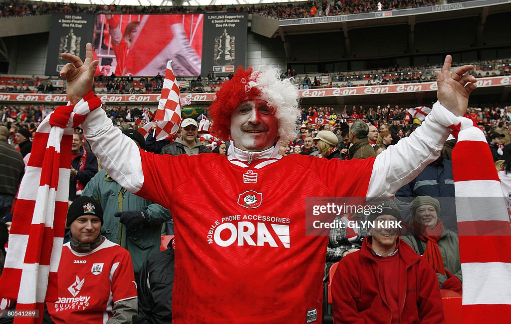A Barnsley football team fan poses befor