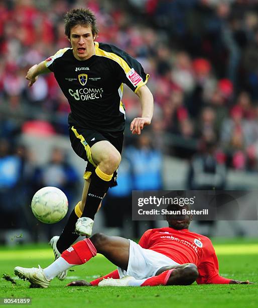 Jamal Campbell-Ryce of Barnsley challenges Aaron Ramsey of Cardiff during the FA Cup sponsored by E.ON Semi-Final match between Barnsley and Cardiff...