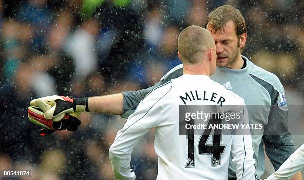 Derby County's Scottish forward Kenny Miller exchanges words with Derby County's Irish goalkeeper Roy Carroll after the English Premier League...