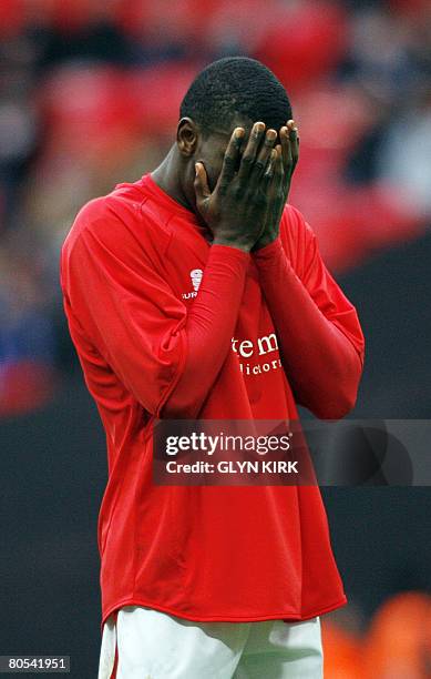 Barnsley's Nigerian Striker Kayode Odejayi reacts after missing a goal attempt during their FA Cup semi final match against Cardiff City at Wembley...