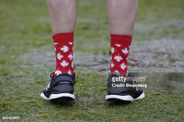 An attendee wears Canadian flag themed socks during the Canada Day event on Parliament Hill in Ottawa, Ontario, Canada, on Saturday, July 1, 2017....