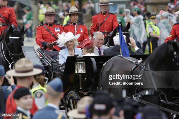 Prince Charles, center right, and Camilla, Duchess of Cornwall, center left, arrive in a horse drawn carriage during the Canada Day event on...
