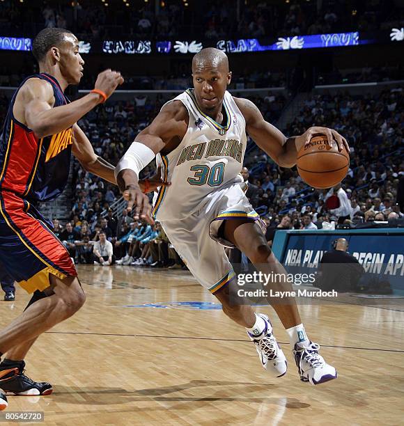David West of the New Orleans Hornets drives around Monta Ellis of the Golden State Warriors on April 6, 2008 at the New Orleans Arena in New...