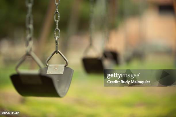 swinging - playground swing stock pictures, royalty-free photos & images