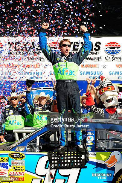 Carl Edwards, driver of the Aflac Ford, celebrates in victory lane after winning the NASCAR Sprint Cup Series Samsung 500 at Texas Motor Speedway on...