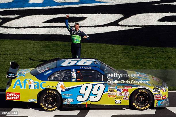 Carl Edwards, driver of the Aflac Ford, celebrates after winning the NASCAR Sprint Cup Series Samsung 500 at Texas Motor Speedway on April 6, 2008 in...