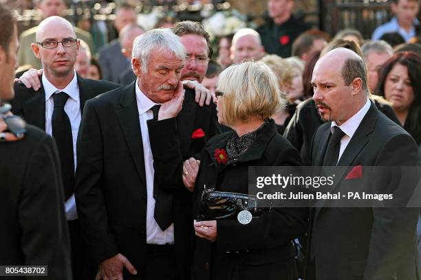 Margaret Gately comforts her husband Martin outside St Laurence O'Toole Church in Dublin where their son Stephen's funeral has been taking place.