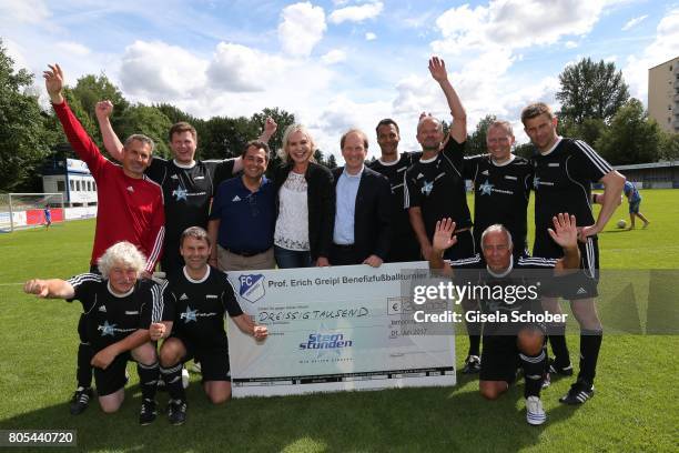 Saskia Greipl and her husband Stavros Kostantinidis and Thomas Jansing with players of 'Sternstunden' Team and check during the Erich Greipl Tribute...