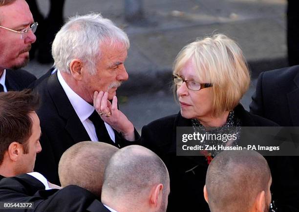 Margaret Gately comforts her husband Martin outside St Laurence O'Toole Church in Dublin where the funeral of their son Stephen has been taking place.