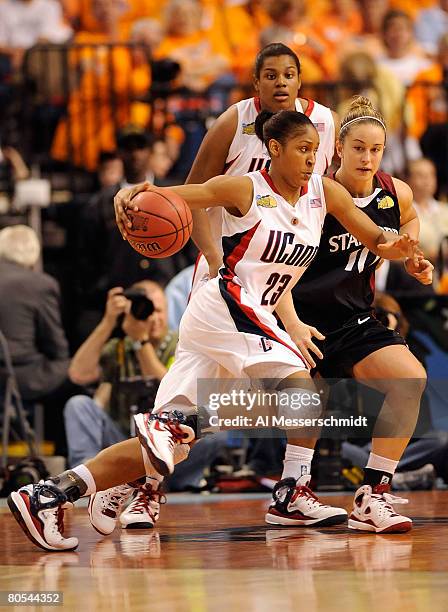 Maya Moore of the UCONN Huskies drives against JJ Hones of the Stanford Cardinal during their National Semifinal Game of the 2008 NCAA Women's Final...