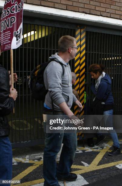 Female protester attempts to get into a gated car parking area as demonstrators picket outside the BBC's Television Centre in White City, west...