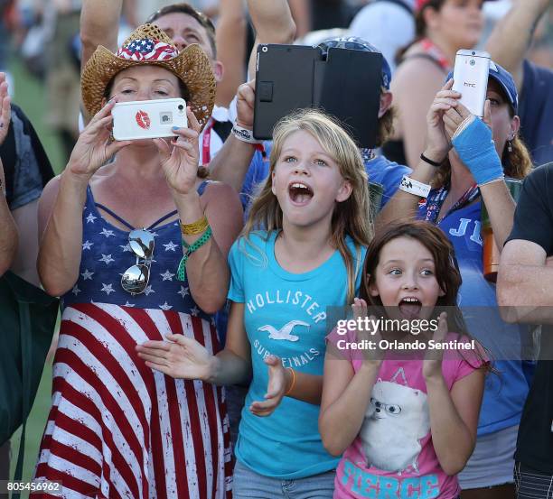 Fans cheer as they see Dale Earnhardt Jr. Before the NASCAR Coke Zero 400 at Daytona International Speedway in Daytona Beach, Fla., on Saturday, July...