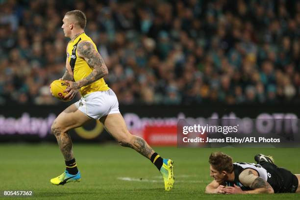 Dustin Martin of the Tigers is tackled by Hamish Hartlett of the Power during the 2017 AFL round 15 match between the Port Adelaide Power and the...