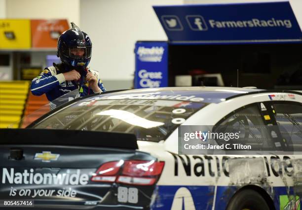 Dale Earnhardt Jr., driver of the Nationwide Chevrolet, removes his helmet in the garage area after being involved in an on-track incident during the...