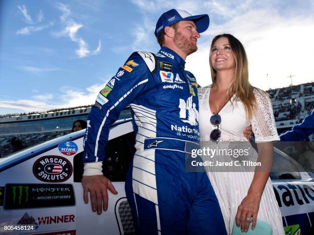 Dale Earnhardt Jr., driver of the Nationwide Chevrolet, and his wife Amy stand on the grid prior to the Monster Energy NASCAR Cup Series 59th Annual...