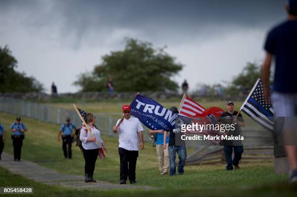 Activists with a Donald Trump and Confederate flag gather at the Gettysburg National Military Park on July 1, 2017 in Gettysburg, Pennsylvania. The...
