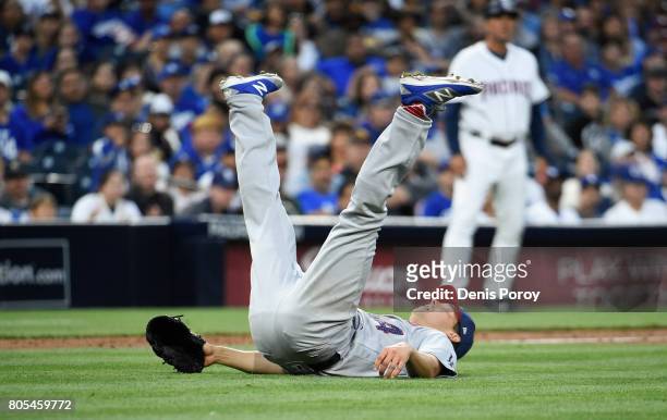 Rich Hill of the Los Angeles Dodgers falls on his back after throwing to first base during the second inning of a baseball game against the San Diego...