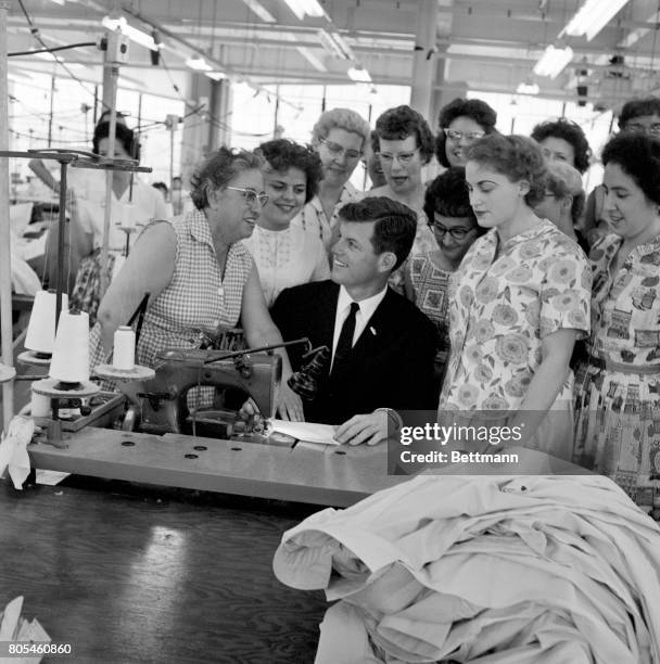 Edward "Ted" Kennedy, youngest brother of the President, is surrounded by employees of the Foster Grant co., in Leominster, one of the many plants he...