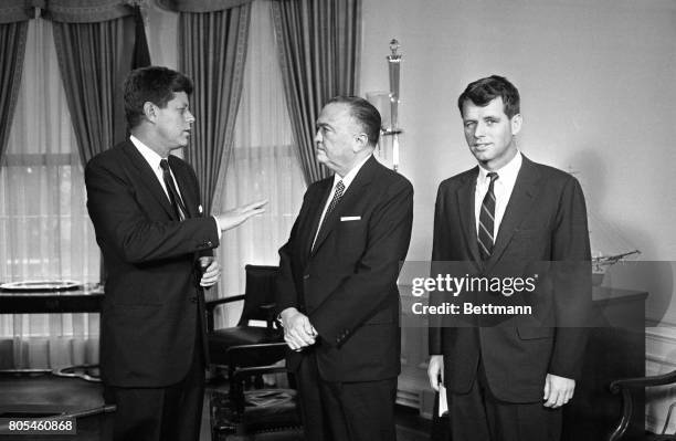 Director J. Edgar Hoover chats with President Kennedy during a visit to the White House 2/23. In center is Attorney General Robert Kennedy, who...