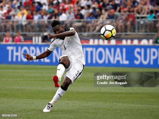 Asamoah Gyan of Ghana scores a goal against the United States defends in the second half during an international friendly between USA and Ghana at...
