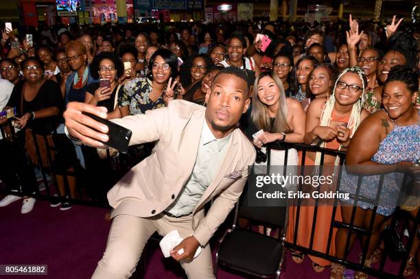 Marlon Wayans poses for a selfie with fans onstage during Netflix At Essence Festival 2017 - Day 2 on July 1, 2017 in New Orleans, Louisiana.