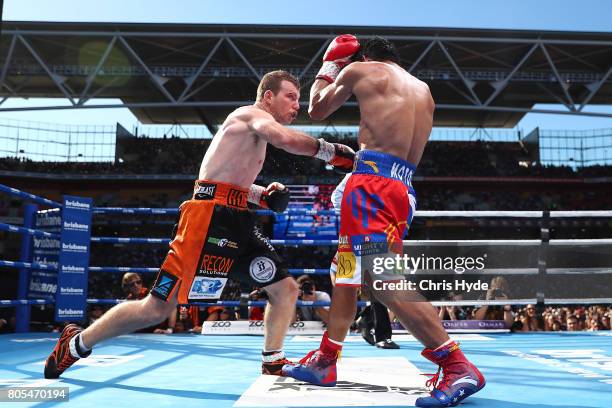 Jeff Horn of Australia and Manny Pacquiao exchange punches during the WBO World Welterweight Title Fight at Suncorp Stadium on July 2, 2017 in...