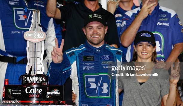 Ricky Stenhouse Jr., driver of the Fifth Third Bank Ford, celebrates in Victory Lane with his girlfriend Danica Patrick, driver of the Aspen Dental...